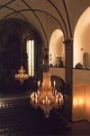 Dvoukolonový lustr pro kostel sv. Šimona a Judy - mosaz, skleněné ověsy, výška 290 cm, průměr 150 cm. V pozadí originál lustru, který jsme restaurovali. Před ním je kopie, kterou jsme podle něj zhotovili